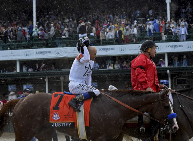 Jockey Mike Smith smiles after riding Justify to win the 144th running of the Kentucky Derby, the wettest in history.