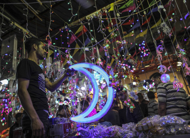 A Palestinian vendor sells Ramadan lanterns in his shop in a market on the first day of the holy month.