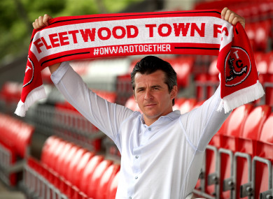 New Fleetwood Town manager Joey Barton holds up a scarf after the press conference at Highbury Stadium.
