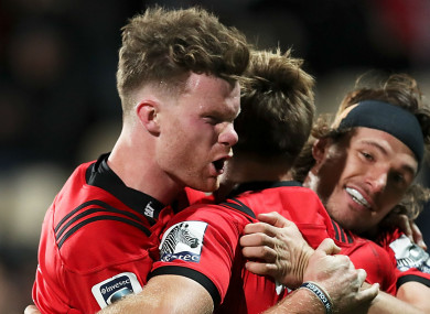 On course: Crusaders players celebrate a try against the Sharks.