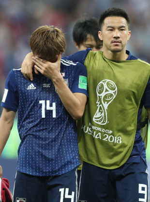 Takashi Inui (L) of Japan reacts after the 2018 FIFA World Cup round of 16 match.