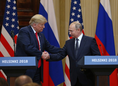 Donald Trump shakes hands with Vladimir Putin during a joint press conference at the Presidential Palace in Helsinki.