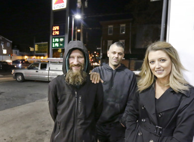 Johnny Bobbitt Jr, left, Kate McClure, right, and McClure's boyfriend Mark D'Amico pose at a Citgo station in Philadelphia.