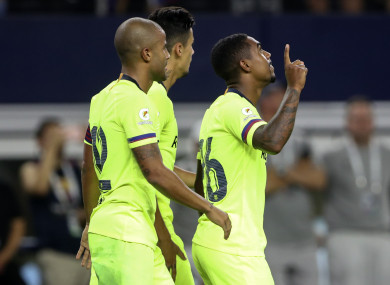 Malcom (right) celebrates his goal.
