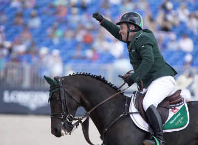 Cian O'Connor, aboard Good Luck, celebrates a clear round in the team and individual jumping championships,