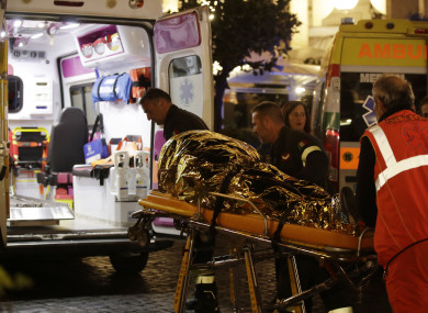 Rescuers evacuate a person who was wounded after the escalator incident.