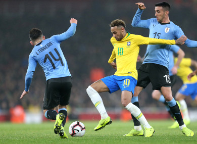 Brazil's Neymar (centre) battles for the ball with Uruguay's Lucas Torreira (left) and Matias Vecino (right).