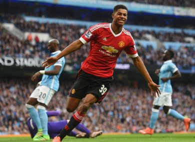 Rashford celebrates scoring against Manchester City.
