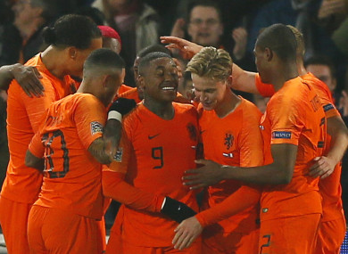 Netherlands players celebrate scoring.