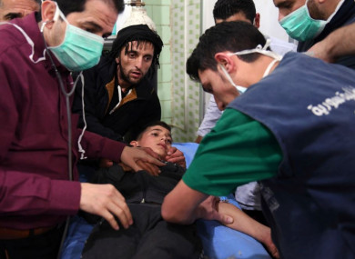 Medical staff treating a boy following a suspected chemical attack on his town of al-Khalidiya, in Aleppo.