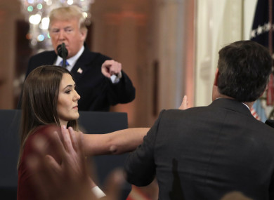 Trump goes on the offensive against reporter Jim Acosta as White House intern attempts to remove his microphone.