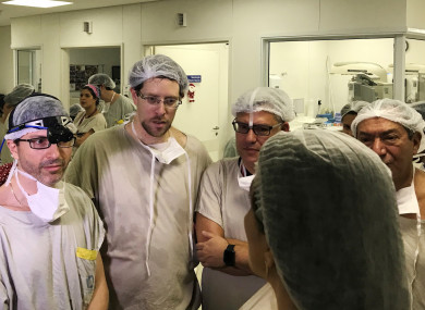 Dr Wellington Andraus, left with magnifying glasses, he and Dr. Dani Ejzenberg, second left, confer with colleagues at the Hospital das Clinicas of the University of Sao Paulo School of Medicine