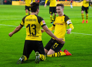 Raphael Guerreiro and Marco Reus celebrating a goal for Borussia Dortmund.