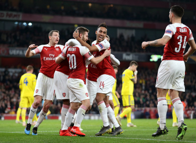 Shkodran Mustafi (centre) is mobbed by teammates after scoring.