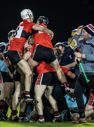UCC celebrate at the final whistle.