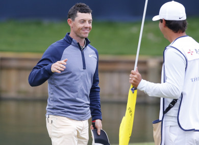 McIlroy celebrates with his caddy Harry Diamond.