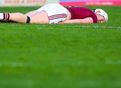 Joe Canning on the deck after a heavy hit from Kevin Moran.