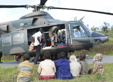 Soldiers and paramedics carry injured survivors from a helicopter in Chimanimani