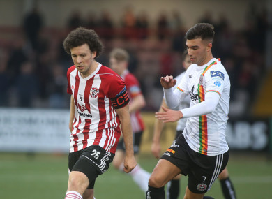 Barry McNamee and Danny Mandroiu battle for the ball.