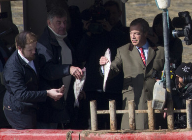 Nigel Farage, right, and Fishing for Leave founder Aaron Brown, left, throw fish into the river Thames as a form of protest (March 2018).