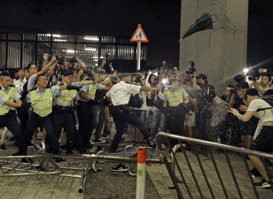 Police officers use pepper spray against protesters