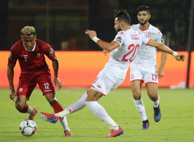 Madagascar's Lalaina Nomenjanahary (L) and Tunisia's Ghaylene Chaalali battle for the ball.