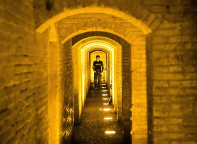 A man walks through the historical Khaju Bridge over the Zayanderud river in Isfahan, Iran.