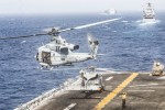 A US helicopter takes off from the assault ship USS Boxer during a transit of the Strait of Hormuz on Thursday.