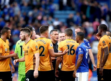 Referee Andre Marriner (centre) speaks to Wolverhampton Wanderers players at the end of the Premier League match.