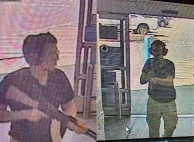 A surveillance stills show alleged gunman Patrick Crusius holding a rifle as he enters a Walmart store.