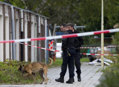 Forensic experts search for evidence in the area where a lawyer who represented a key witness in a major Dutch organised crime trial was gunned down in Amsterdam.