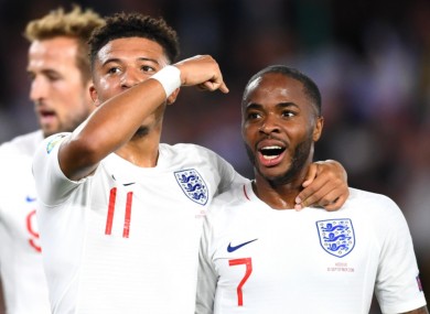 Jadon Sancho celebrates with Raheem Sterling.