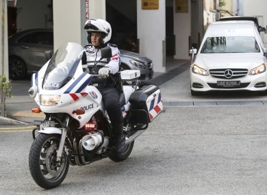 Police motorcycle escorting the hearse