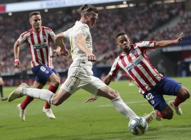 Renan Lodi blocks a pass by Real Madrid's Gareth Bale.