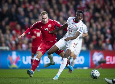 Denmark's Christian Eriksen, left, and Switzerland's Denis Zakaria challenge for the ball.