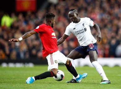 Fred attempting to tackle Sadio Mane in Sunday's 1-1 draw with Liverpool.
