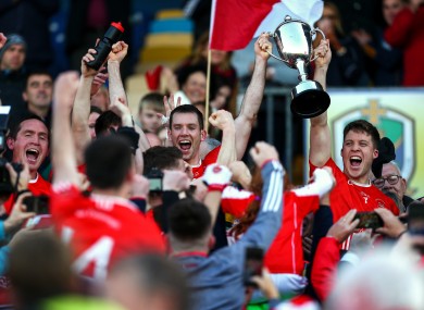 Niall Carty and Ronan Daly lift the cup after Padraig Pearses triumphed.