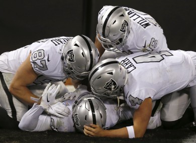 Raiders running back Josh Jacobs celebrates with teammates after scoring against the Los Angeles Chargers.