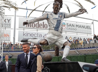 David Beckham and his wife, Victoria, with his LA Galaxy statue.