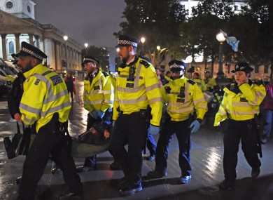 Police remove an Extinction Rebellion protester from Trafalgar Square in London last month