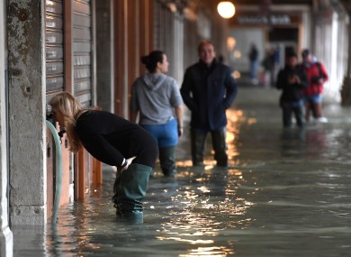 People wading through the floods.