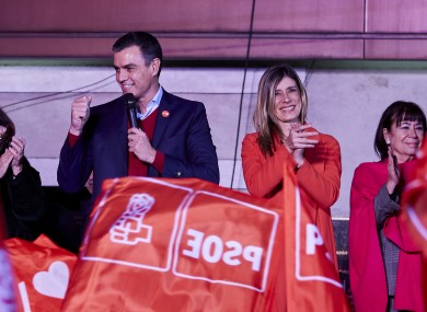 Spanish Prime Minister Pedro Sanchez thanks his supporters as they wave flags outside of the PSOE headquarters in Madrid