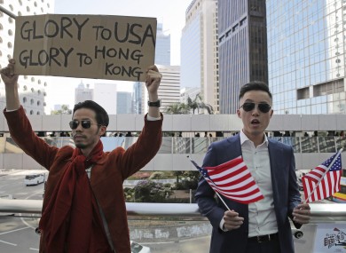 Protesters hold American flags during demonstration in Hong Kong.