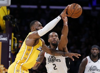 Kawhi Leonard (right) challenges with LeBron James during the Clippers' win over the Lakers.