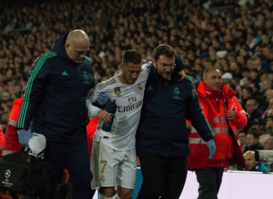 Eden Hazard is helped off the field by medical staff during the Champions League game with PSG.