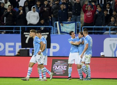 Lazio players celebrate after they score during their Super Cup match against Juventus.