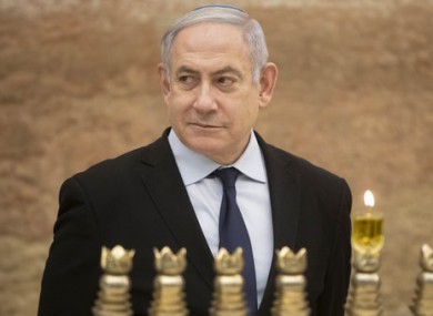 Israeli Prime Minister Benjamin Netanyahu lighting a Hanukkah candle at the Western Wall.