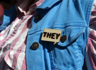 A person with a 'They' pin at a transgender community march in the US in October 2018.