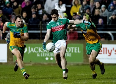 James Durcan in action for Mayo against Donegal's Conor O'Donnell and Caolan Ward.
