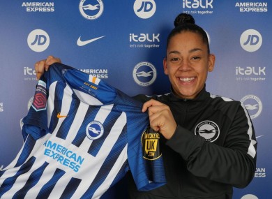 Jarrett holding up the Albion shirt.